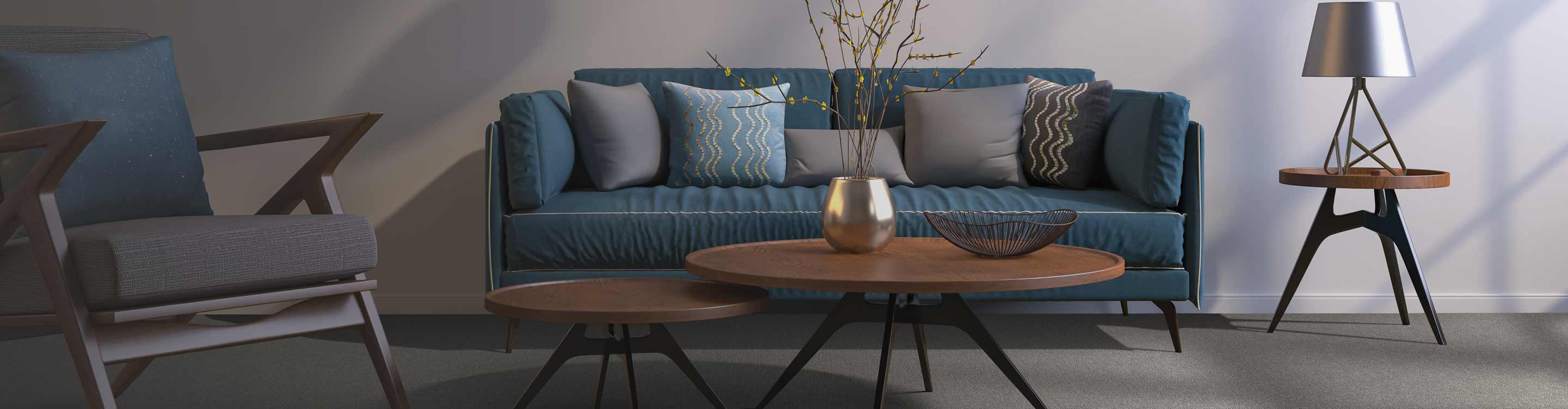 dark gray carpet with a blue couch and gray paint